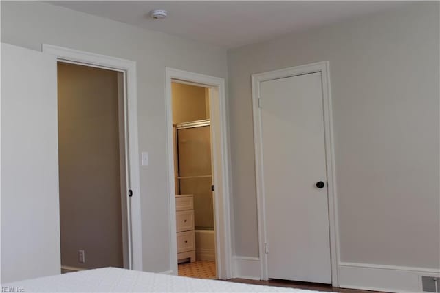 unfurnished bedroom with visible vents and ensuite bathroom