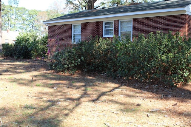 view of side of home featuring brick siding
