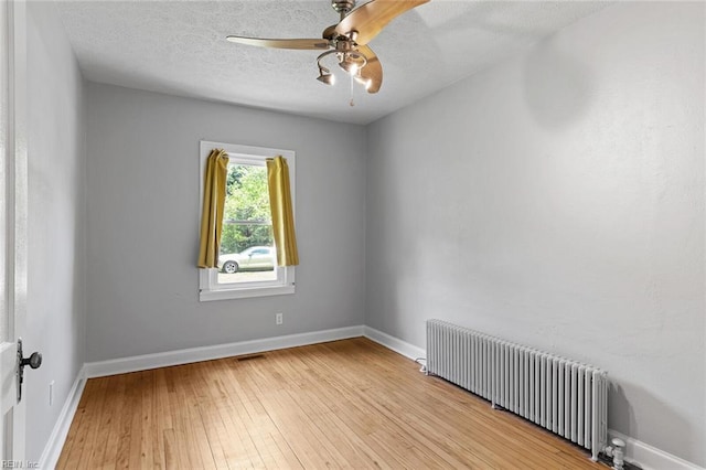 33 Mennonite Ln, Newport News, VA 23602 - spare room featuring baseboards, light wood-style flooring, radiator heating unit, and a ceiling fan