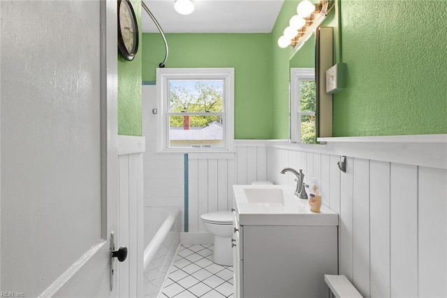 33 Mennonite Ln, Newport News, VA 23602 - bathroom featuring a wainscoted wall, a bathing tub, toilet, vanity, and tile patterned flooring