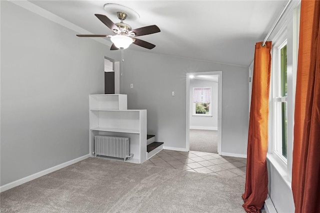 33 Mennonite Ln, Newport News, VA 23602 - unfurnished living room featuring carpet flooring, baseboards, radiator heating unit, a ceiling fan, and tile patterned flooring