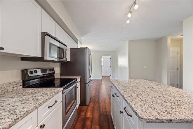 kitchen featuring white cabinetry, stainless steel appliances, dark wood-style floors, and a center island