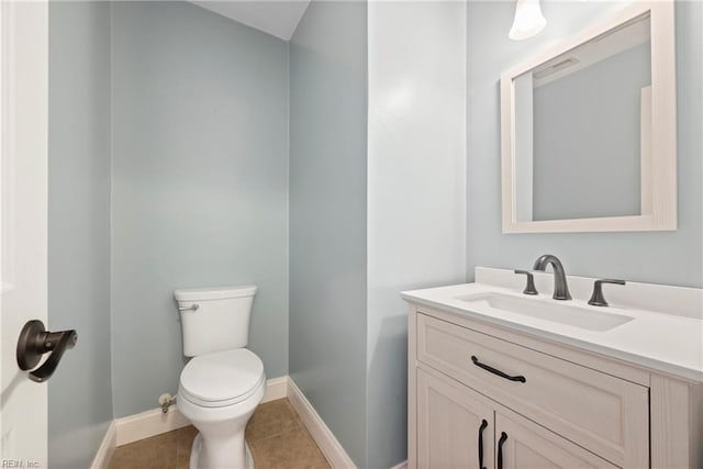 bathroom featuring tile patterned floors, vanity, toilet, and baseboards