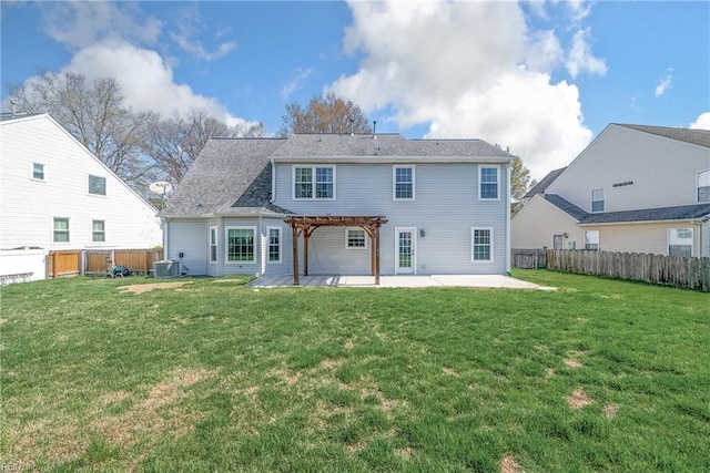back of property featuring a fenced backyard, a pergola, a yard, and a patio area