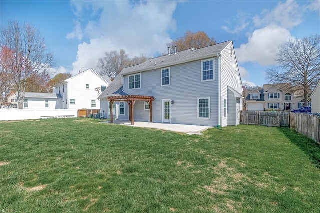 back of house featuring a fenced backyard, a lawn, a pergola, and a patio area