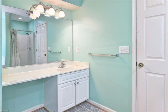 full bathroom with curtained shower, vanity, and baseboards