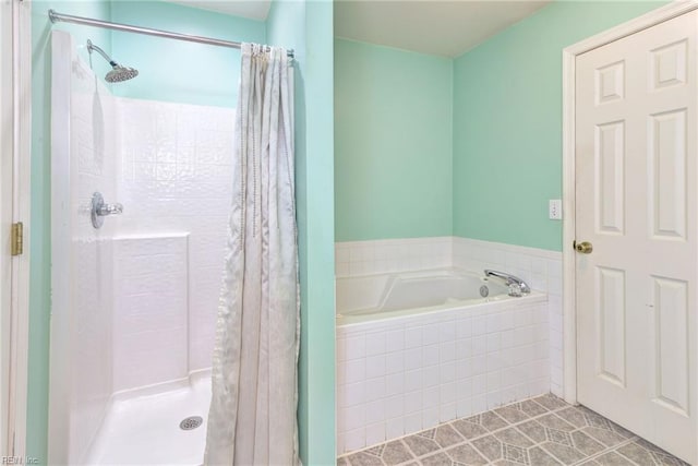 full bath featuring a shower stall and a garden tub