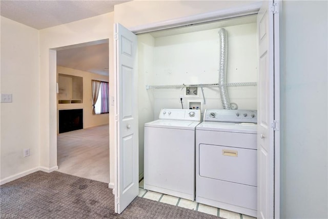 washroom with baseboards, washing machine and dryer, laundry area, and light colored carpet