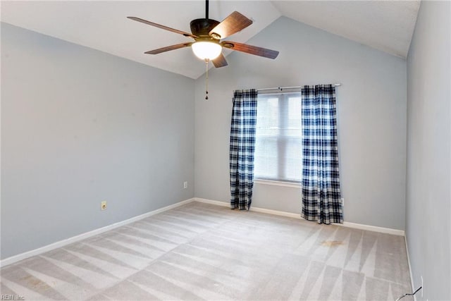 unfurnished room with baseboards, a ceiling fan, light colored carpet, and vaulted ceiling