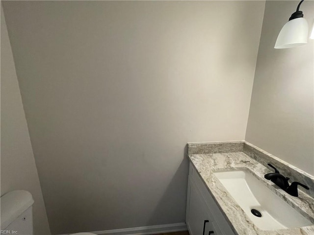 bathroom with toilet and vanity