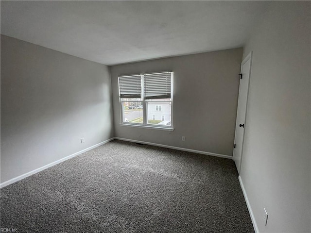 carpeted spare room with baseboards