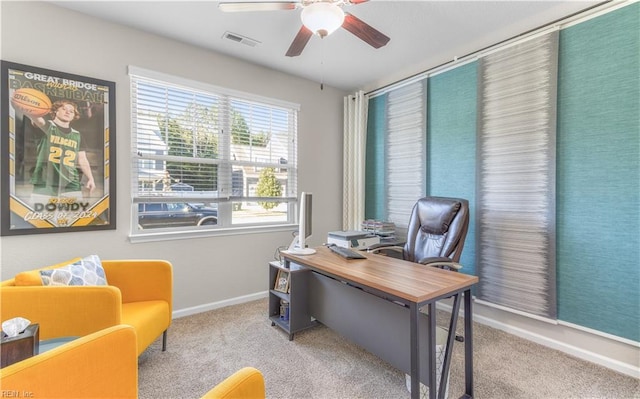 home office with baseboards, carpet floors, visible vents, and a ceiling fan