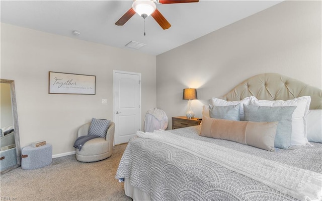 carpeted bedroom featuring visible vents, baseboards, and ceiling fan