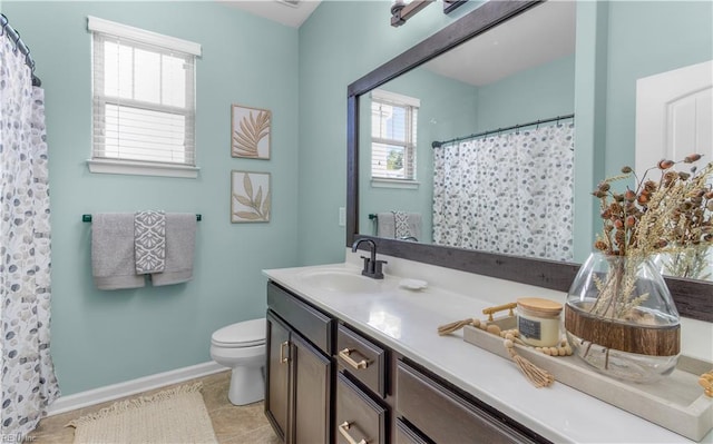 bathroom with a shower with shower curtain, toilet, vanity, tile patterned flooring, and baseboards