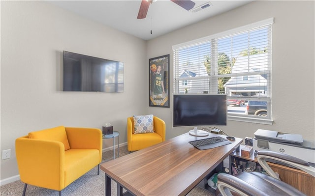 office featuring baseboards, carpet floors, visible vents, and a ceiling fan