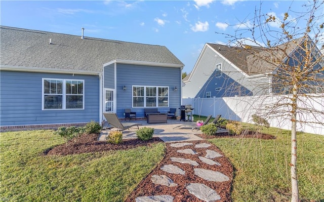 back of house with a yard, a shingled roof, fence, and a patio area