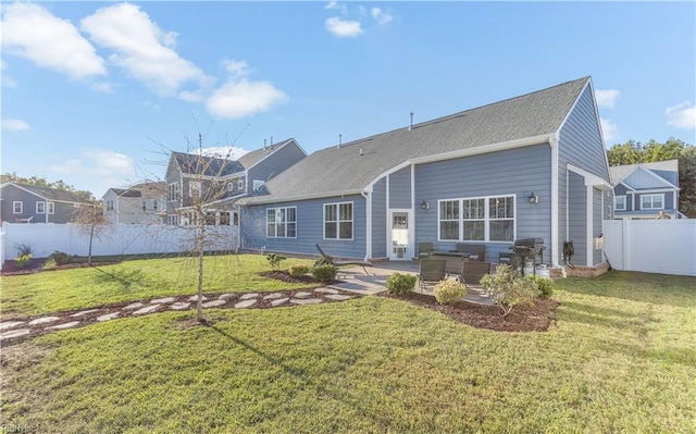 back of house featuring a patio, fence, and a yard