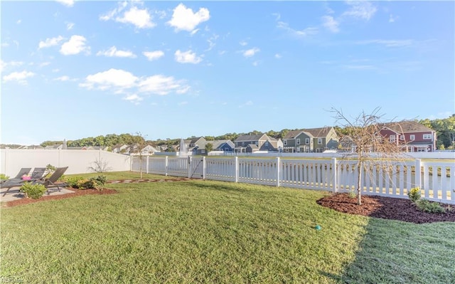 view of yard with a fenced backyard and a residential view