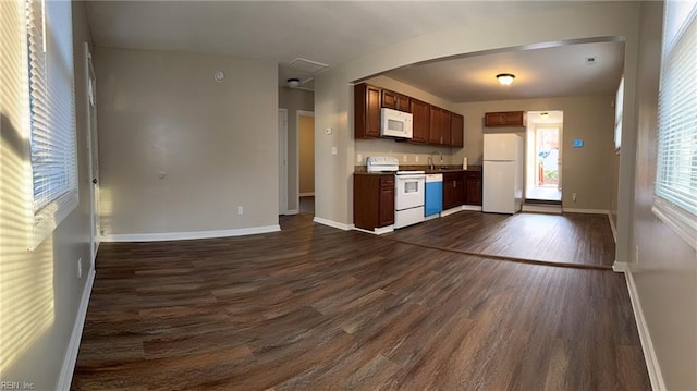 816 Westwood Ave, Hampton, VA 23661 - kitchen featuring white appliances, baseboards, dark countertops, dark wood-type flooring, and a sink