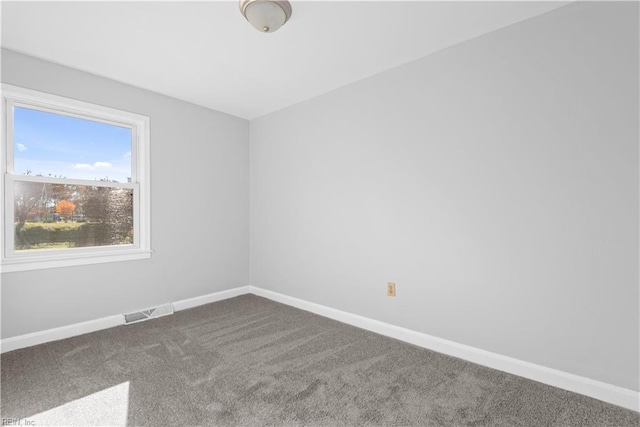 carpeted spare room with baseboards and visible vents