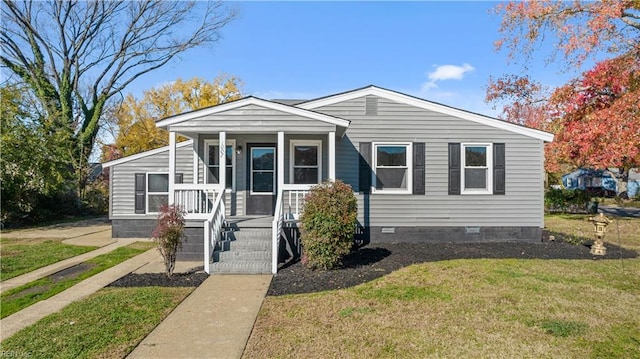 view of front facade featuring covered porch, a front lawn, and crawl space