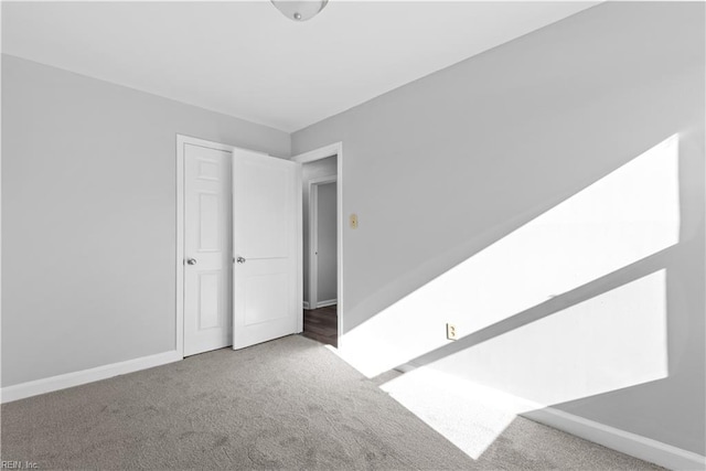 spare room with carpet floors and baseboards