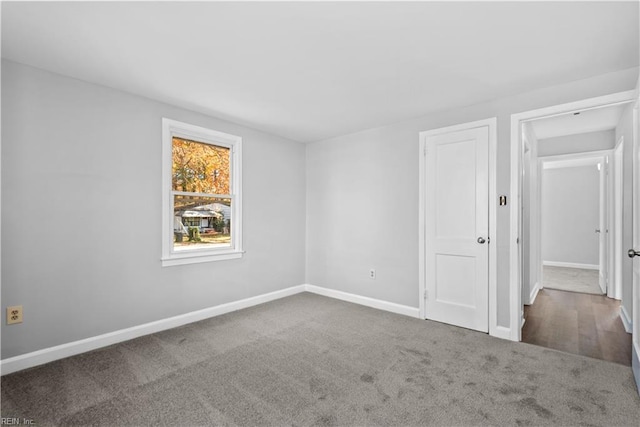 carpeted empty room with baseboards
