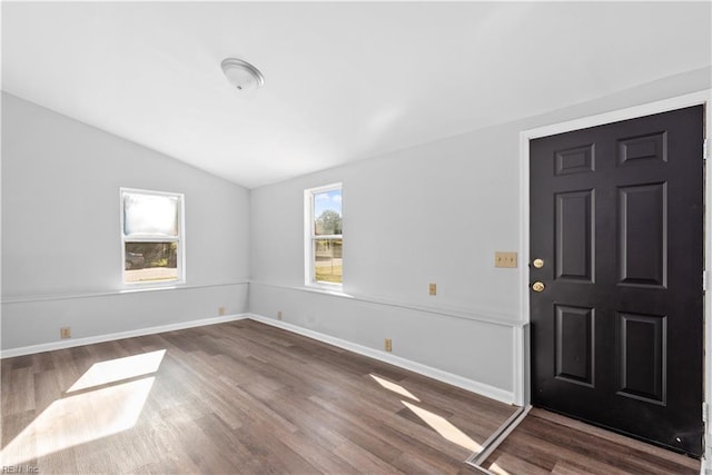 entryway featuring dark wood-style floors, lofted ceiling, and baseboards