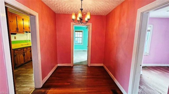 380 Hobson Ave, Hampton, VA 23661 - hallway featuring dark wood finished floors, baseboards, a notable chandelier, and visible vents