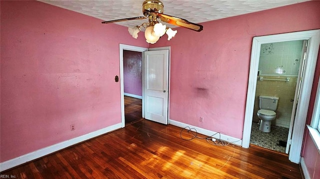 380 Hobson Ave, Hampton, VA 23661 - unfurnished bedroom featuring baseboards, wood finished floors, ensuite bath, and a textured ceiling