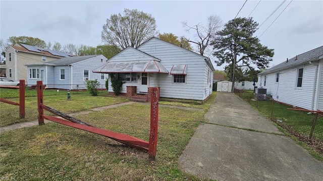 380 Hobson Ave, Hampton, VA 23661 - bungalow featuring an outdoor structure, concrete driveway, fence, a front yard, and a storage shed