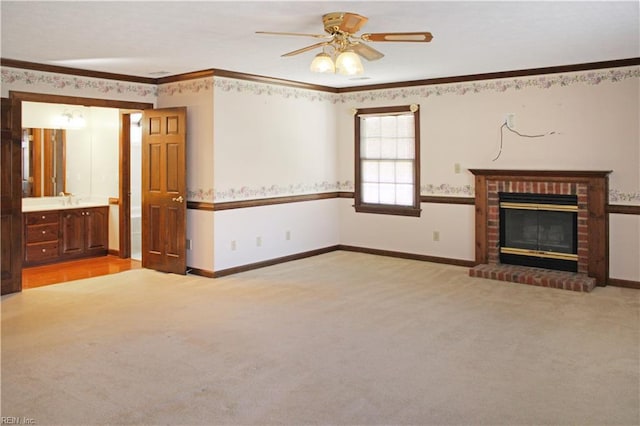 unfurnished living room with light carpet, a fireplace, baseboards, ceiling fan, and ornamental molding