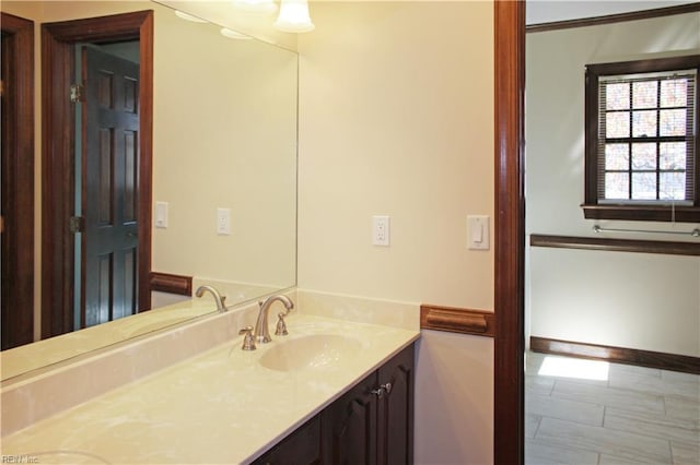 bathroom featuring baseboards and vanity