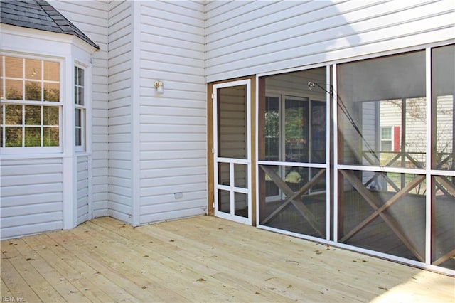 wooden deck featuring a sunroom