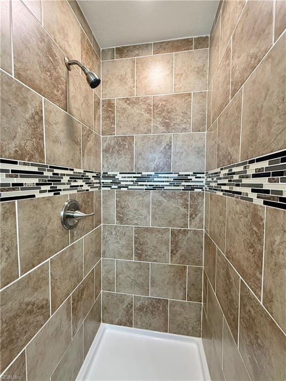 full bathroom with a tile shower