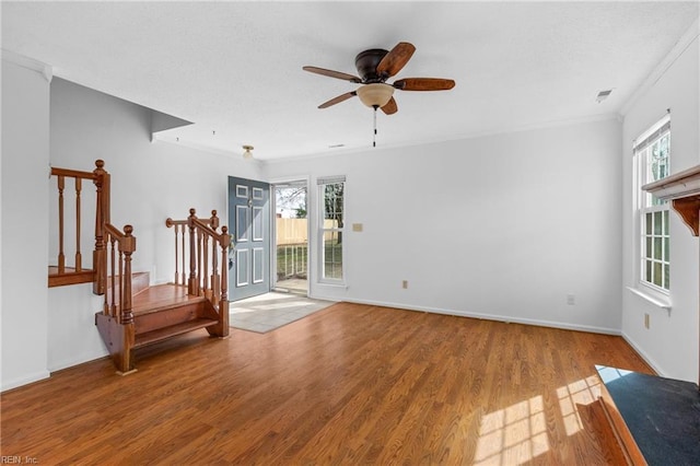 724 Oleander Cir, Virginia Beach, VA 23464 - unfurnished living room featuring a wealth of natural light, wood finished floors, a ceiling fan, and ornamental molding