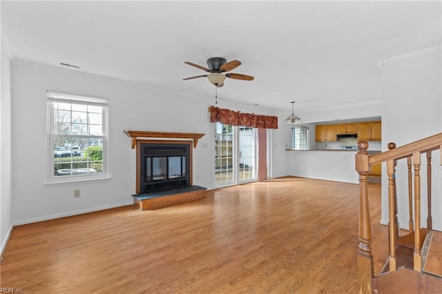 724 Oleander Cir, Virginia Beach, VA 23464 - unfurnished living room with stairway, light wood-type flooring, ornamental molding, ceiling fan, and a glass covered fireplace