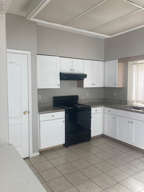 kitchen featuring black / electric stove, under cabinet range hood, white cabinetry, and a sink