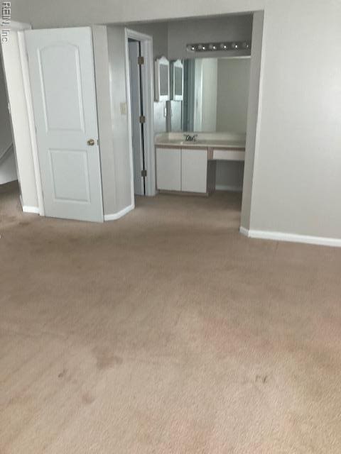 unfurnished bedroom with baseboards and carpet