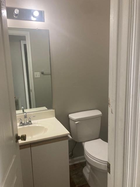 half bathroom with toilet and vanity