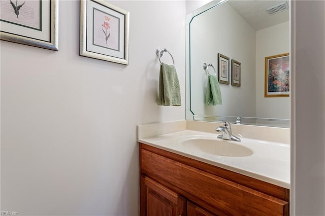 bathroom with vanity and visible vents