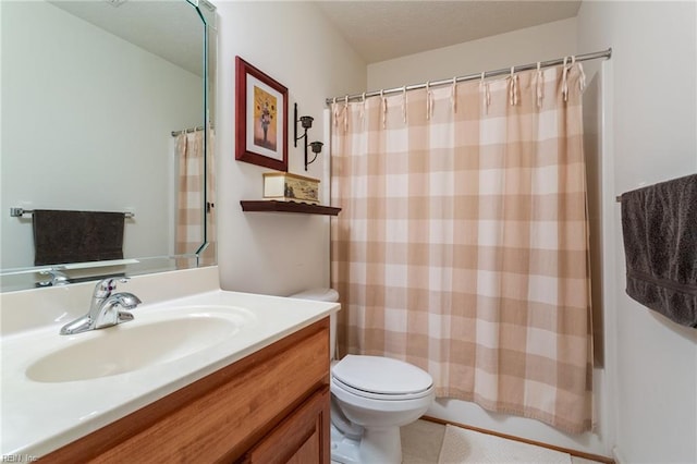 bathroom with toilet, vanity, tile patterned flooring, and a textured ceiling