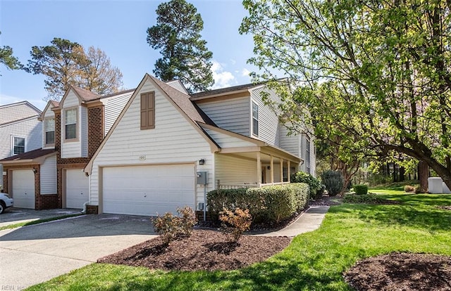 view of front of house featuring concrete driveway, a garage, and a front lawn