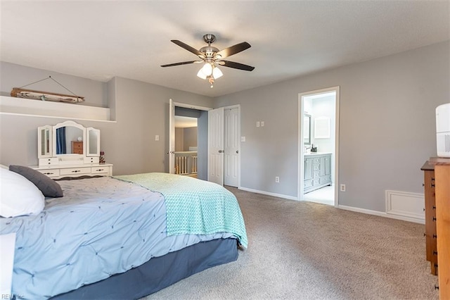 carpeted bedroom with connected bathroom, baseboards, and a ceiling fan