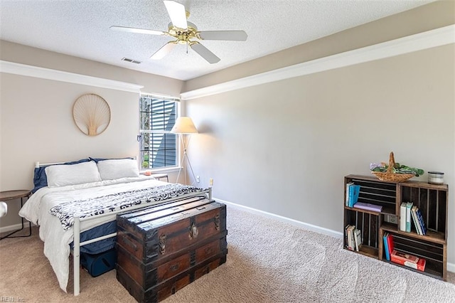 bedroom with carpet flooring, baseboards, a textured ceiling, visible vents, and a ceiling fan