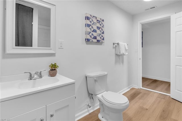 1438 Lasalle Ave, Portsmouth, VA 23704 - bathroom with visible vents, toilet, vanity, and wood finished floors