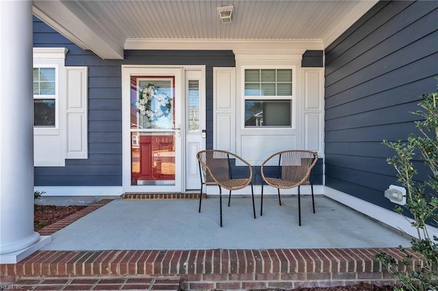view of exterior entry featuring covered porch