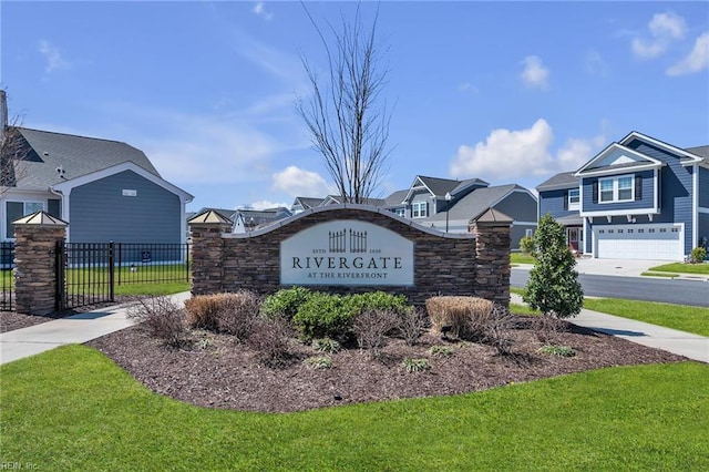 community / neighborhood sign featuring a residential view, fence, and a lawn