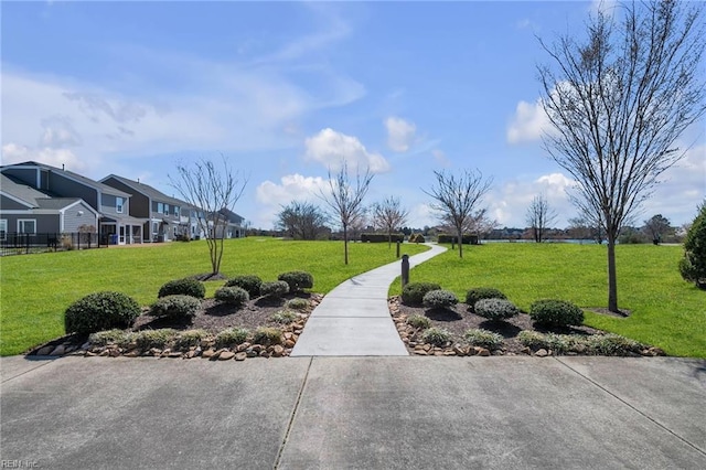 view of property's community with a yard