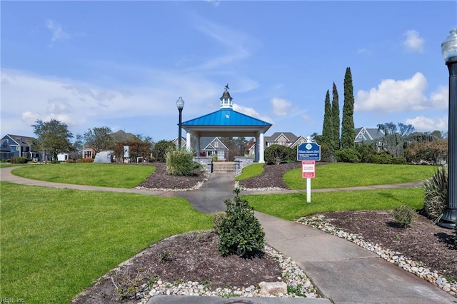 view of property's community with a gazebo and a lawn